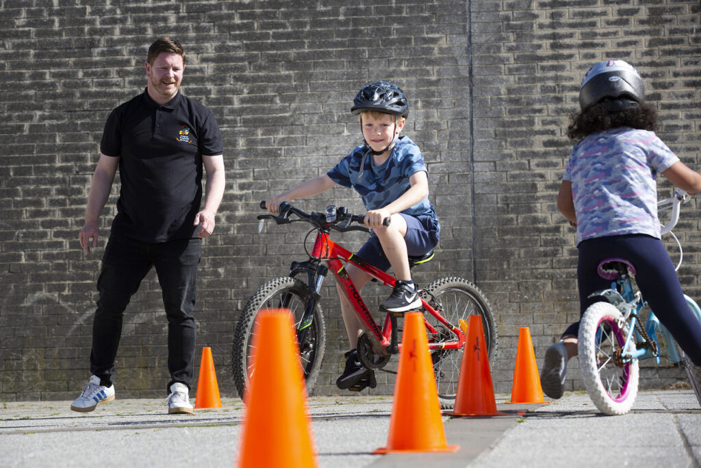 children learning to ride bikes through the Go Smarter Go Active Cycling Roadshow as part of the Active Travel campaign.